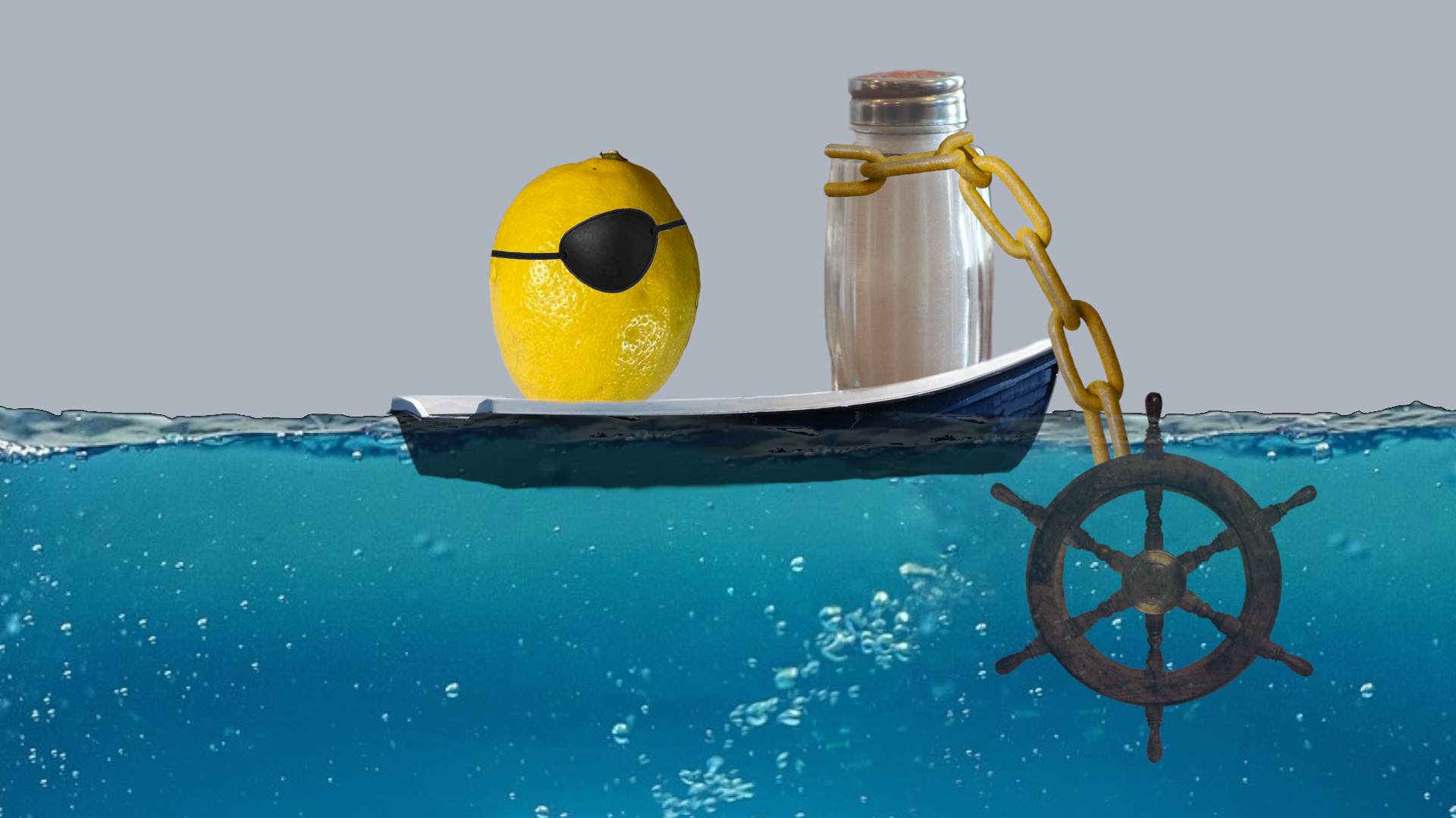 A lemon with a black eyepatch. A salt shaker with chain around it attached to boat wheel. They are on a boat on water.