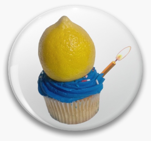 Lemon on blue cupcake with lit candle