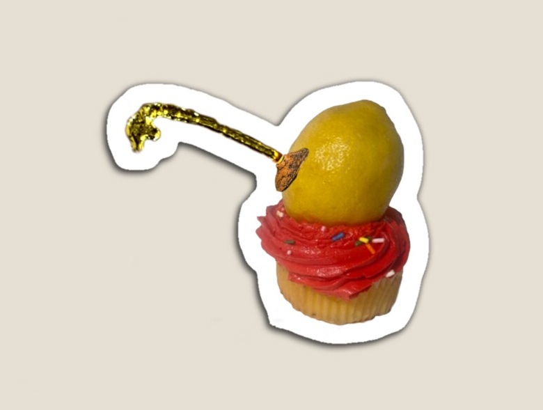 Lemon on red cupcake spraying juice